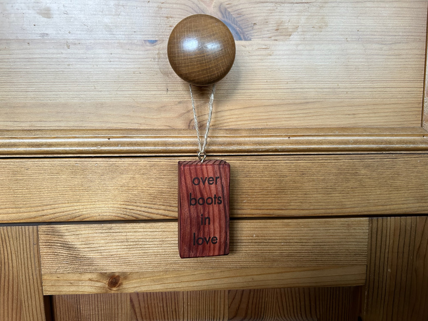 Wooden Hanging Decoration: Redwood. 'over boots in love...'